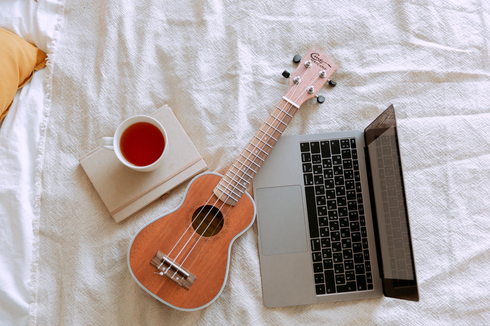 top view of morning learning ukulele play process in bed